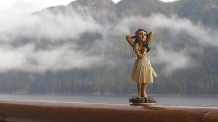 Wall Mural - Hula dancer hawaii souvenir girl doll on Alaska cruise ship deck travel trip - funny vacation concept background. Autumn Alaska holiday.