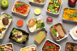 © New Africa - Lunchboxes on grey table, flat lay. Healthy food delivery