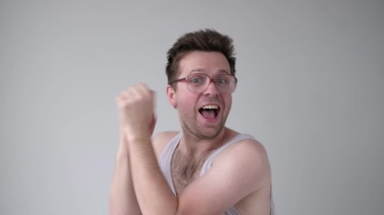 Wall Mural - Young happy drunk man in glasses dancing after party.