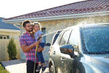 Sticker - Dad and daughter washing car at backyard on sunny day