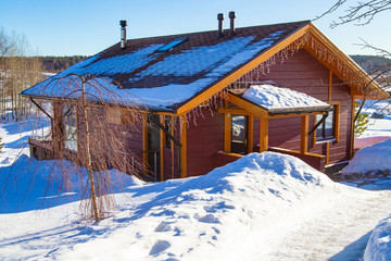Poster - Cottage with garlands. The house stands among the snowdrifts. Rest in winter. Apartment. Rent cottages. The house is located in Karelia. Sale of cottages.