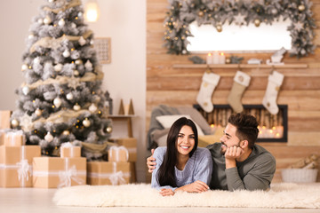 Wall Mural - Happy couple in living room decorated for Christmas