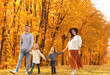 © New Africa - Happy family with little daughters walking in autumn park