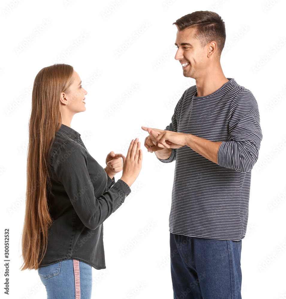Young deaf mute couple using sign language on white background