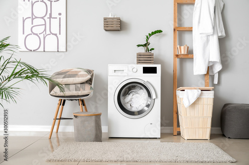 Fotomural Interior of home laundry room with modern washing machine