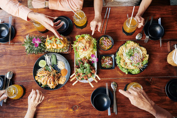 Poster - Group of people having dinner with various traditional Asian dishes and drinks, view from above