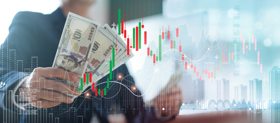 Poster - Businessman holding banknote and financial stock market graph on color city background, currency exchange, for finance and business concept.