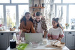 © zinkevych - Daughters watching recipe video on laptop with daddy