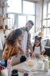 © zinkevych - Cheerful daughters and daddy enjoying cooking together