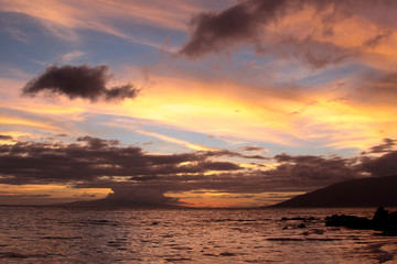 Wall Mural - Scenic sunset from Kamaole Beach I, Maui, Hawaii. Setting sun color blue sky and clouds in bright orange, red and yellow colors