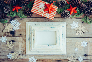 Wall Mural - Christmas background with frame and gift boxes on the wooden tab