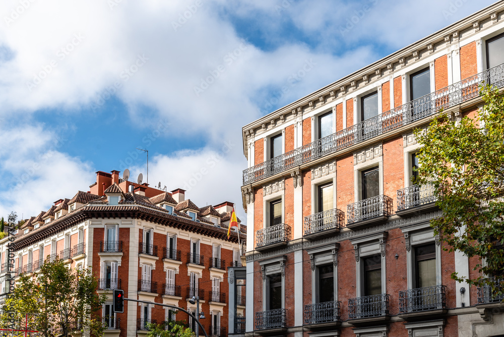 Old luxury residential buildings with balconies in Serrano Street in Salamanca district in Madrid - obrazy, fototapety, plakaty 