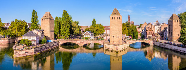 Wall Mural - Panoramic view of the Ponts Couverts (covered bridges), a medieval set of bridges and defensive towers on the river Ill at the entrance of the Petite France historic quarter in Strasbourg, France.