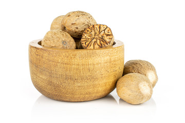 Wall Mural - Group of five whole one half of dry brown nutmeg in tiny wooden bowl isolated on white background