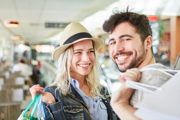 Happy teenage couple shopping