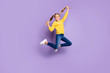 © deagreez - Full body photo of cheerful cute kid have fun on spring holidays jump hold pigtails wear casual style clothing sneakers isolated over violet color background