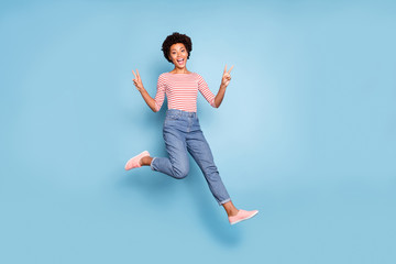 Canvas Print - Turned full length body size photo of cheerful positive cute pretty nice girlfriend running jumping showing double v-sign in jeans denim striped shirt curly wavy isolated pastel blue color background