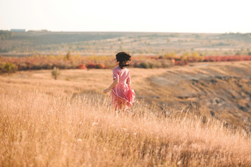 Wall Mural - laughing woman running away in field