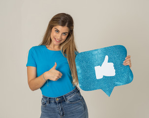 Happy young woman holding Like symbol in internet networking and social media notification icons