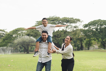 Wall Mural - happy family  in the park, family asian group relation quality healthy support, home park .