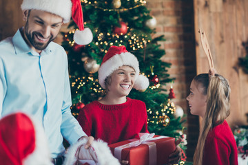 Wall Mural - Photo of cheerful positive nice cute brother overjoyed about gifts sister with anltered horns on head rejoicing in her brother happiness