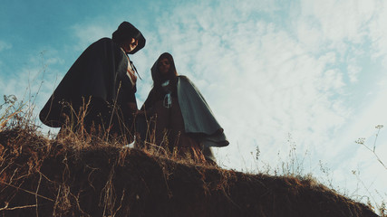 The guy with the girl from the Victorian era standing over cliff and holding hands. Excellent video for Halloween Day