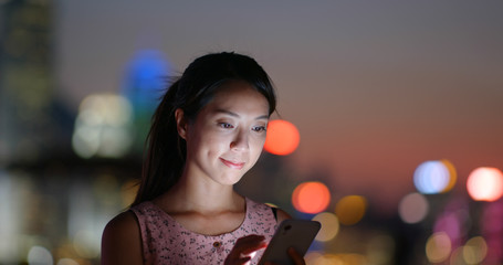 Wall Mural - Woman use of smart phone at night