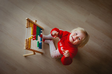 little girl playing with abacus, learning numbers