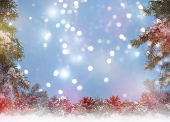 Wall Mural - Christmas background. Fir branches on snow background bokeh light