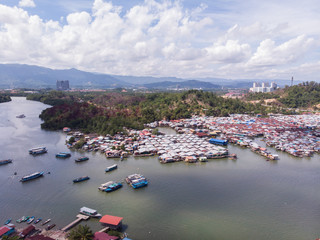 Wall Mural - Top down aerial view of the water village houses in a small village Beside river at Sabah, Borneo