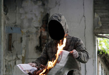 Invisible Man Burning Newspaper Inside Ruin House