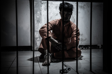 Asian man desperate at the iron prison,prisoner concept,thailand people,Hope to be free,Serious prisoners imprisoned in the prison