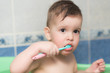 © johnalexandr - lovely baby brushing his teeth with a toothbrush in the bathroom