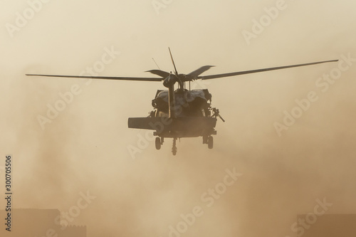 Cuadros en Lienzo Military chopper takes off in combat and war flying into the smoke and chaos and destruction