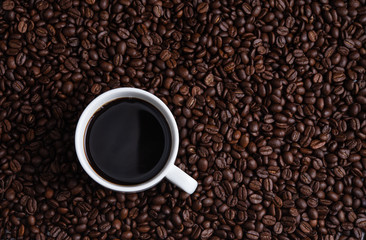 cup of coffee espresso on coffee beans brown seed texture background full wallpaper