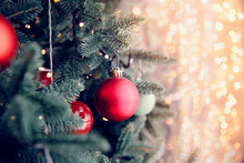 Christmas Background Tree New Yeae Branch With Decorations Red Balls Gifts And Star, With Bokeh Light. Copy Space