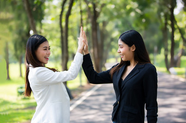 Two women joyful together in park 