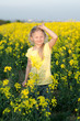 © katarinagondova - adorable charming blond girl with hands up in yellow meadow