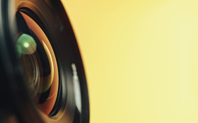 Aufkleber - Beautiful camera lens with yellow and pink light of glass on a black background...