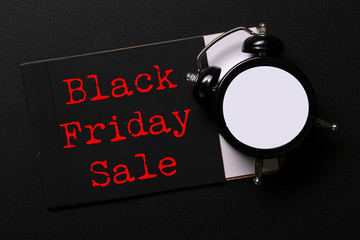 Wall Mural - Black friday sale concept. Fourth Friday of November, beginning of Christmas shopping season since 1952. Old alarm clock, text on paper textured background. Copy space, close up, top view, flat lay