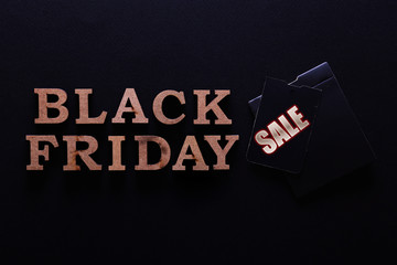 Wall Mural - Black friday sale concept. Fourth Friday of November, beginning of Christmas shopping season since 1952. Price tag with text on paper textured background. Copy space, close up, top view, flat lay