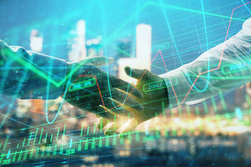 Double exposure of financial chart on cityscape background with two businessmen handshake. Concept of financial analysis and investment opportunities