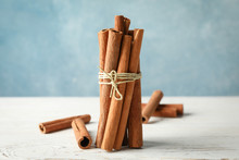 Cinnamon Sticks On White Wooden Background, Space For Text