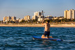 a young man floating on a SUP-board on the sea