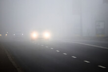 Motion Of Cars With Headlights On During Heavy Fog_
