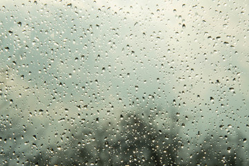 Beautiful sky and clouds, rain, wet glass, drops of water on the glass, drops of water on the window, drops