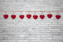 Red Handmade Textured Hearts Hanging On A Rope On A White Brick Wall Background. Image Of Valentines Day, Birthday, Love Consept.