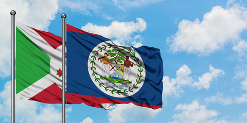 Burundi and Belize flag waving in the wind against white cloudy blue sky together. Diplomacy concept, international relations.