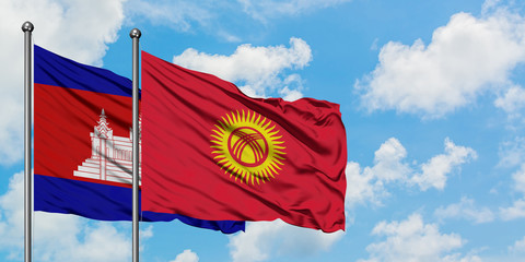 Cambodia and Kyrgyzstan flag waving in the wind against white cloudy blue sky together. Diplomacy concept, international relations.