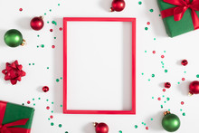 Christmas Modern Composition. Red Photo Frame, Xmas Decorations On White Background. Christmas, New Year, Winter Concept. Flat Lay, Top View, Copy Space